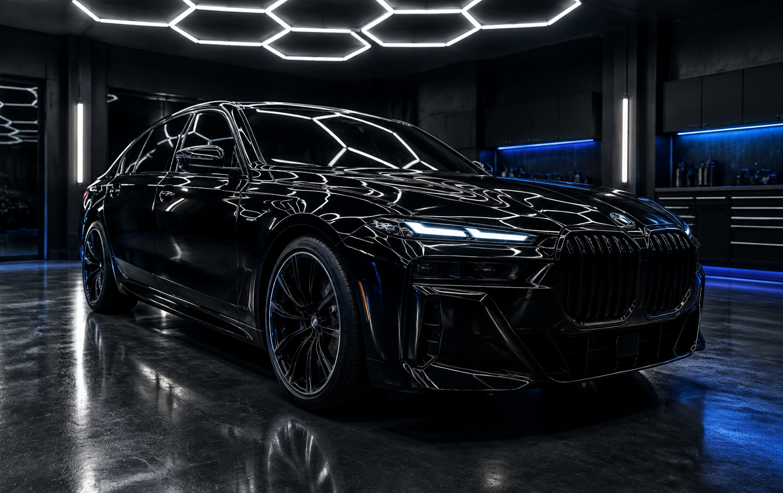 Glossy black sedan in a professional detailing studio